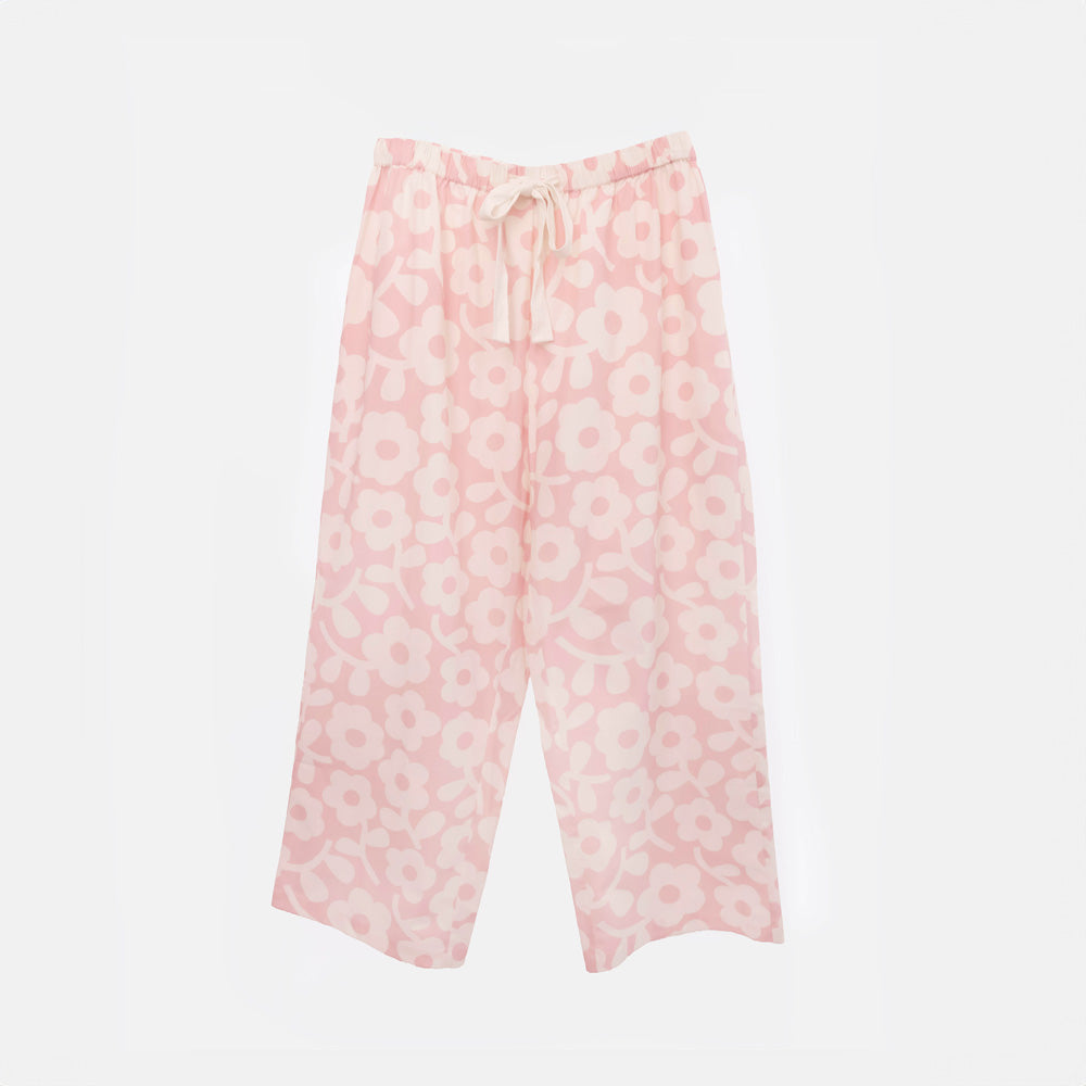 Wide-leg pale pink pyjama trousers with a cream flower print and a cream drawstring tie