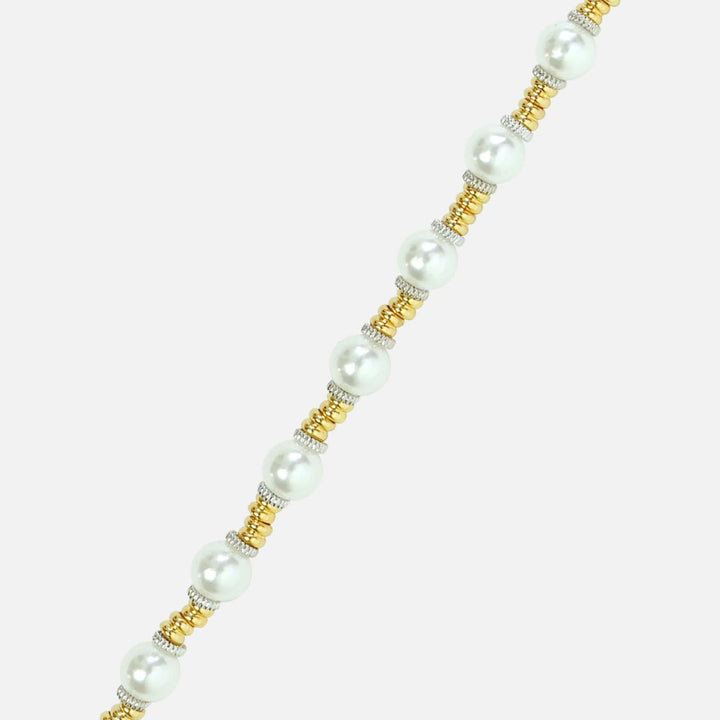 Close-up of creamy pearls between gold and silver beads