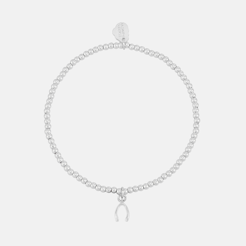 Silver beaded stretch bracelet with a small wishbone charm and heart tag