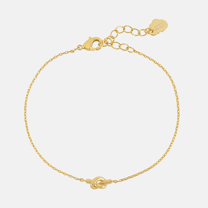 Fine gold chain bracelet with a small knot at the centre and a gold extender chain