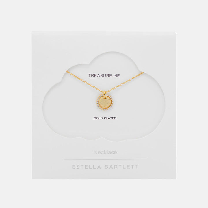 Fine gold chain necklace with a round hammered coin pendant edged in sparkling stones, presented on a white cloud-shaped card reading Treasure Me