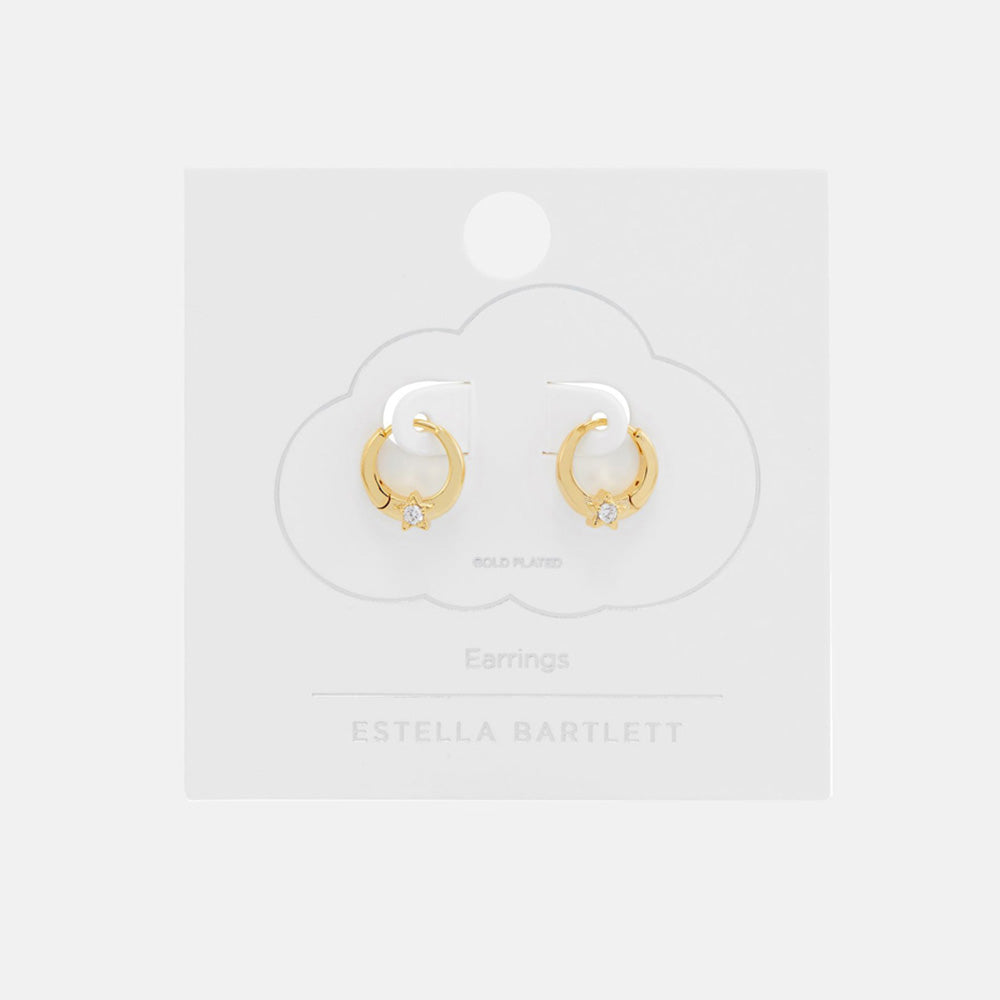 Pair of small gold huggie hoop earrings, each set with a sparkling star, on a white cloud-shaped earring card