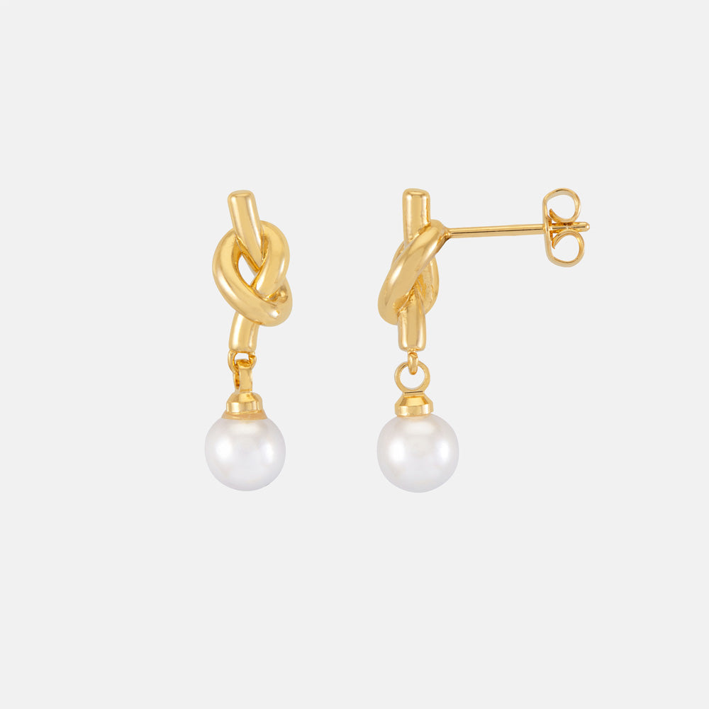Gold knot pearl drop earrings on a white cloud-shaped gift card