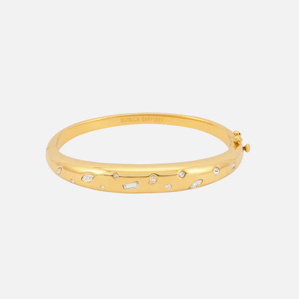 Gold domed hinged bangle scattered with small round and baguette sparkling stones