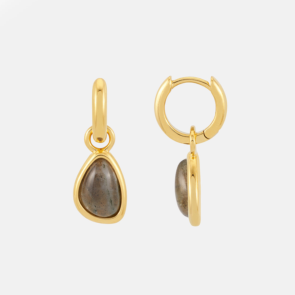 Pair of gold huggie hoops with teardrop grey labradorite charms set in gold