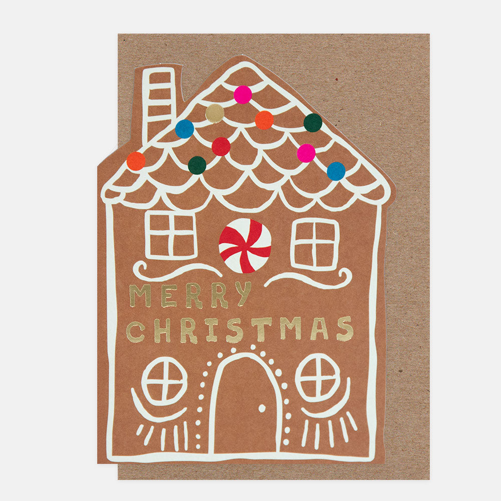 Die cut gingerbread house christmas card with 'Merry Christmas' text on a brown background