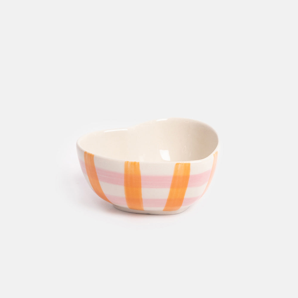 Small heart shaped ceramic bowl with pink and orange check on a white background