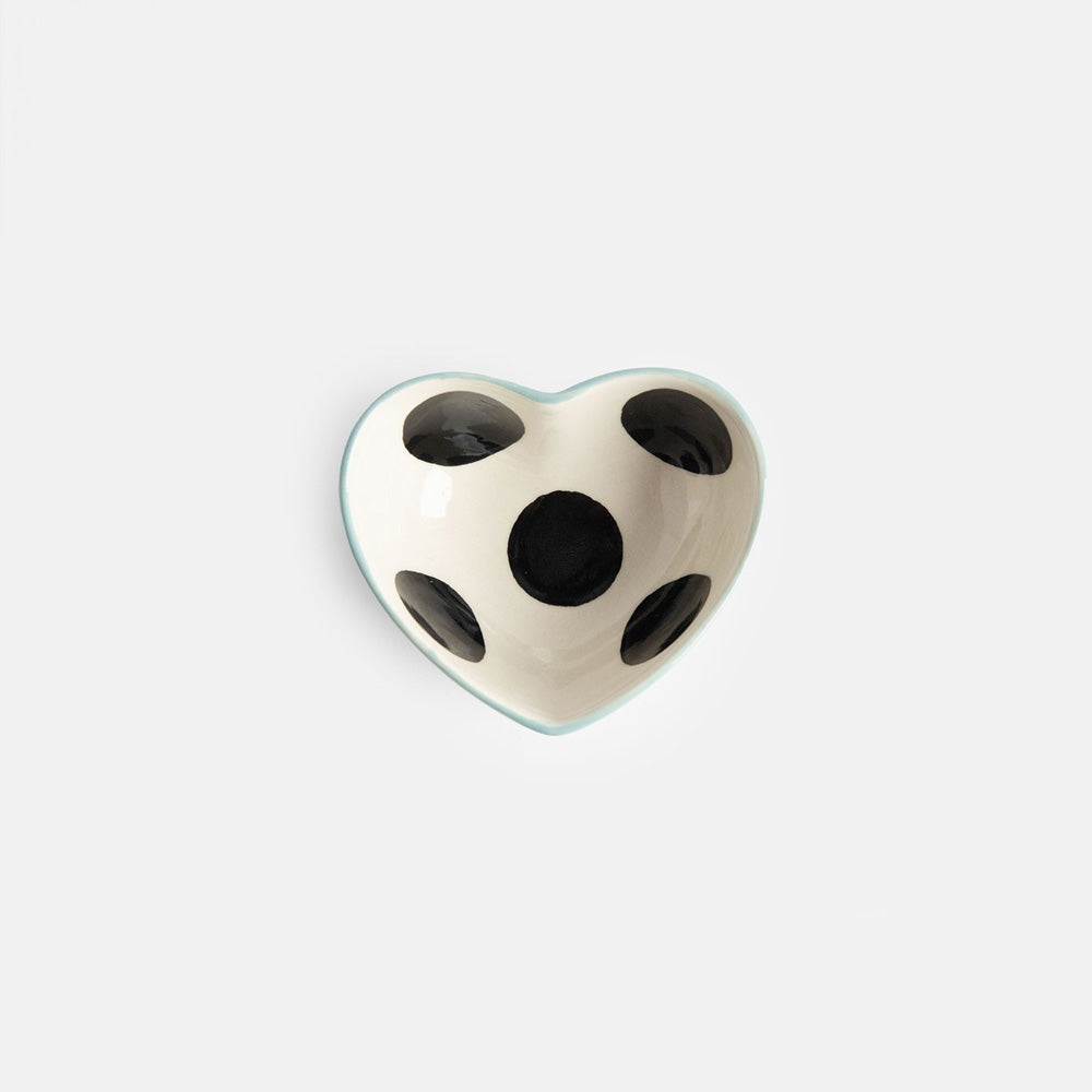 heart shaped hand painted glazed ceramic stoneware trinket bowl qith a black spot inside and light blue outer design