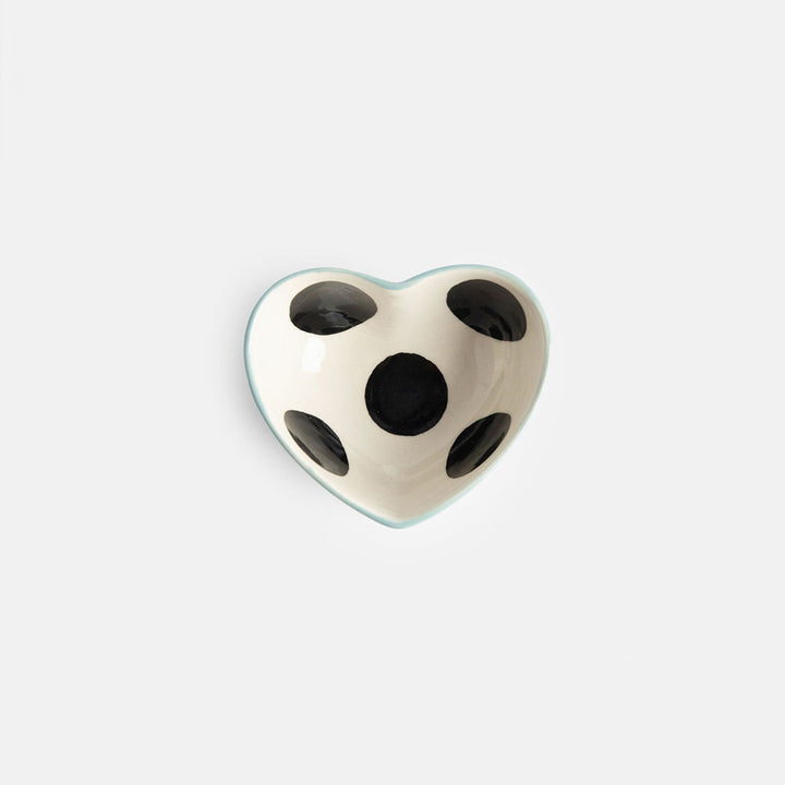 heart shaped hand painted glazed ceramic stoneware trinket bowl qith a black spot inside and light blue outer design