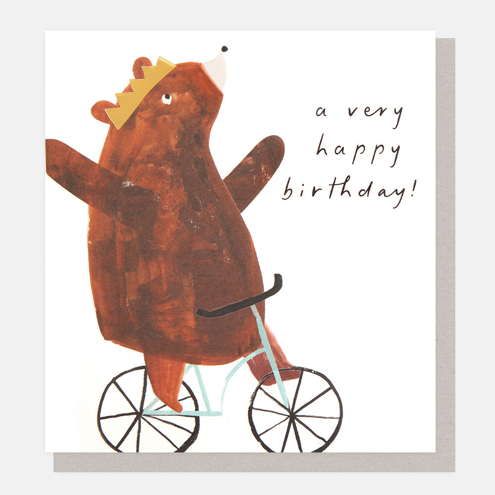 brown bear wearing a gold crown and riding a bike a very happy birthday card