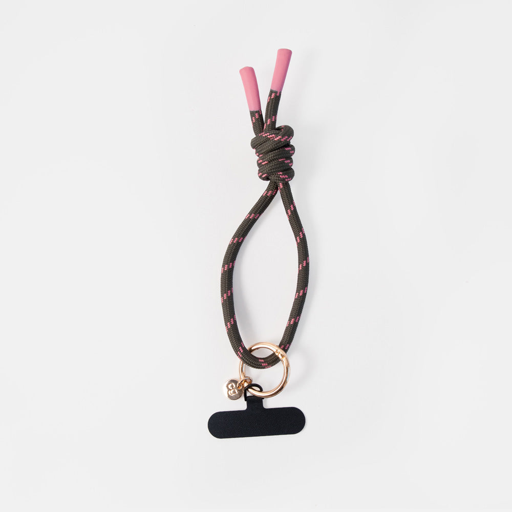 dark green wristlet phone strap with pink accents and attached o-ring and clip to attach to a smartphone