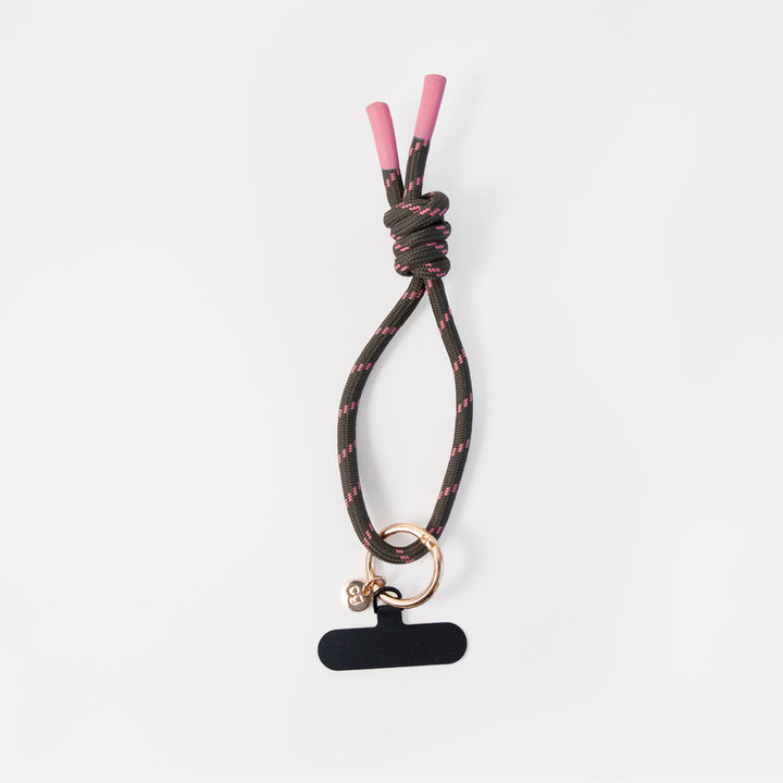 dark green wristlet phone strap with pink accents and attached o-ring and clip to attach to a smartphone