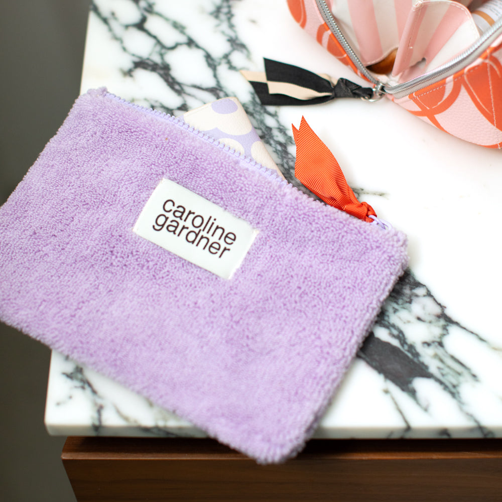 lilac towelling zipped pouch on a marble surface