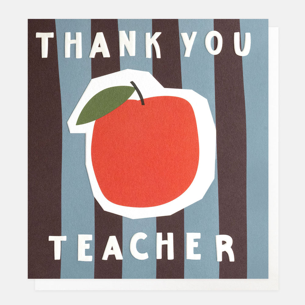 A square greetings card with a sticker style red apple on burgundy and blue vertical stripes and the text 'thank you teacher' in white embossed lettering, shown with a white envelope behind it.