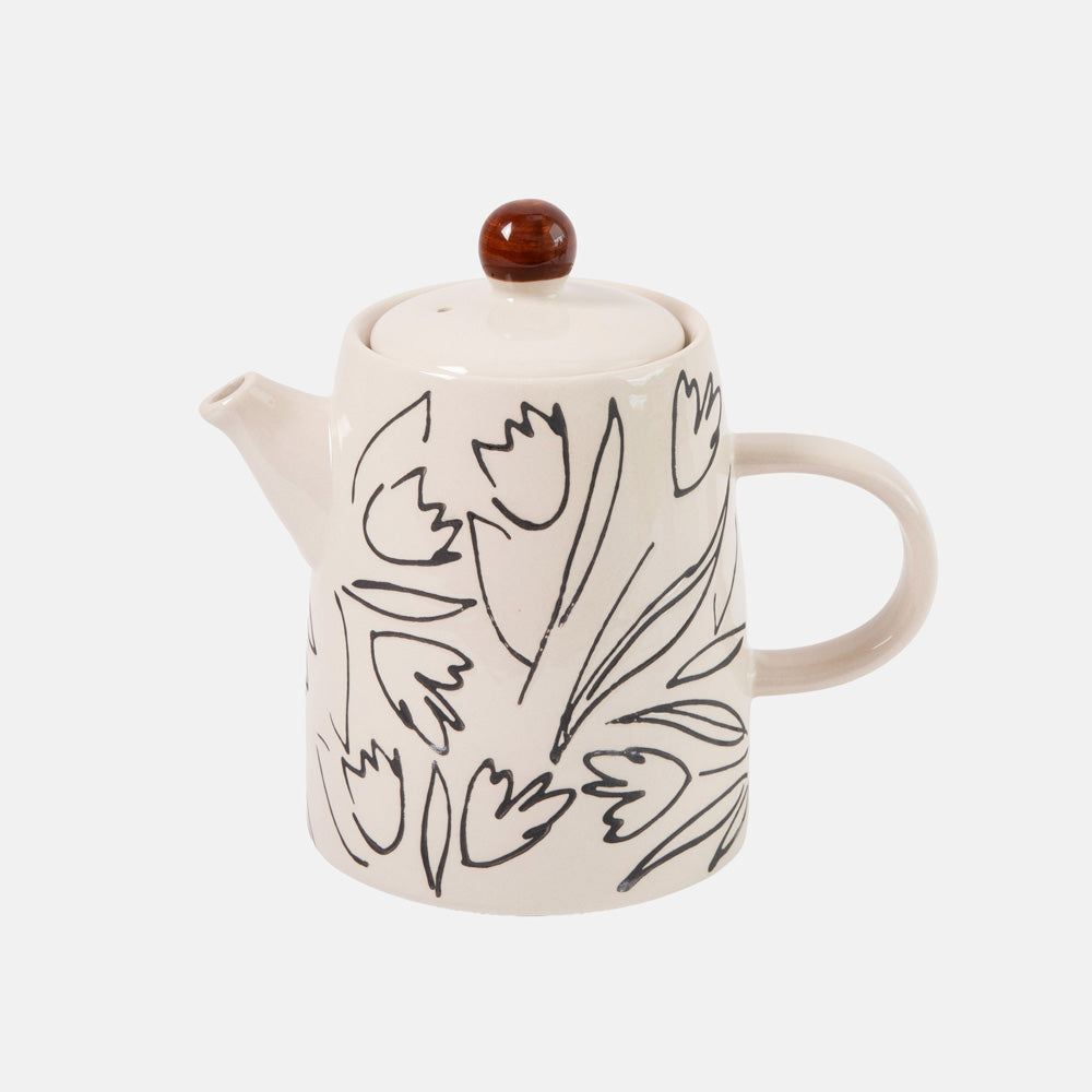 An off-white ceramic teapot decorated with black line-art tulips, featuring a dark brown lid knob, set against a light gray background.