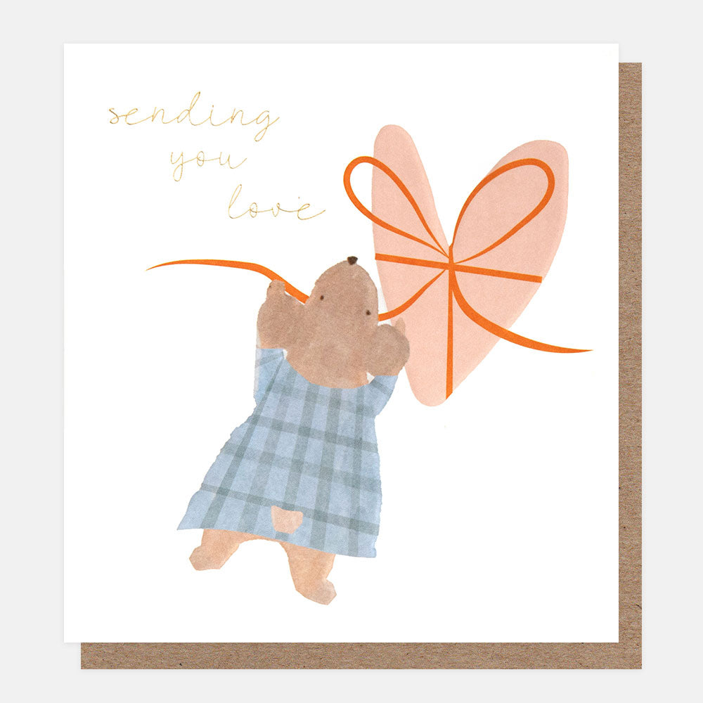 greetings card featuring a mouse in a blue gingham dress holding up a pink heart with an orange ribbon around it and the words sending you love in gold script