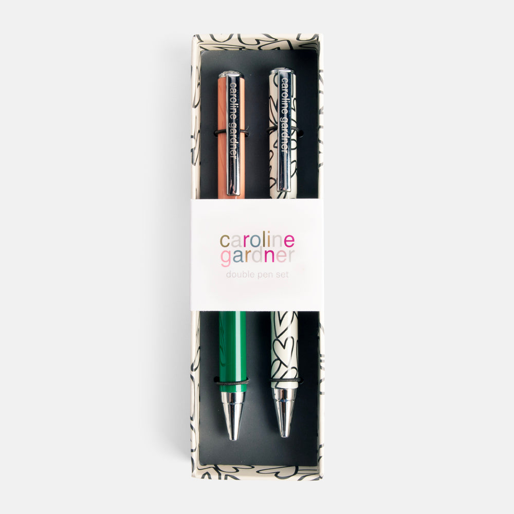 set of 2 black ink ballpoint pens in green & pink and monochrome heart print in a presentation box