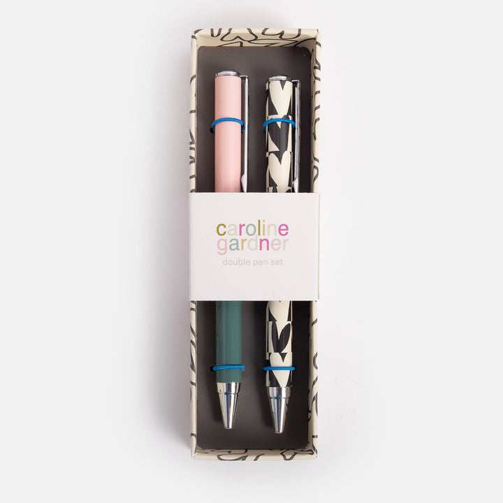 set of 2 boxed ballpoint pens, one in block green & pink the other in monochrome hearts print