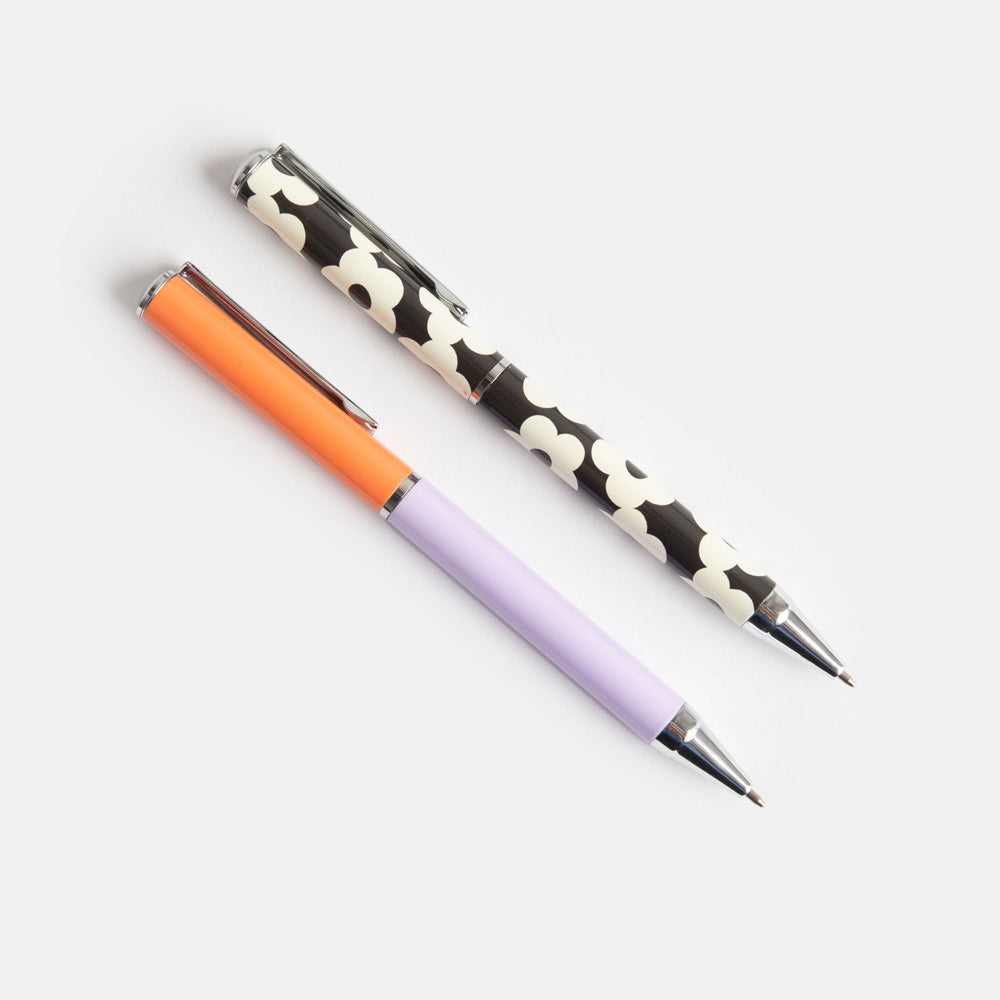 set of 2 boxed ballpoint pens, one in block lilac & coral, the other in monochrome flowers print