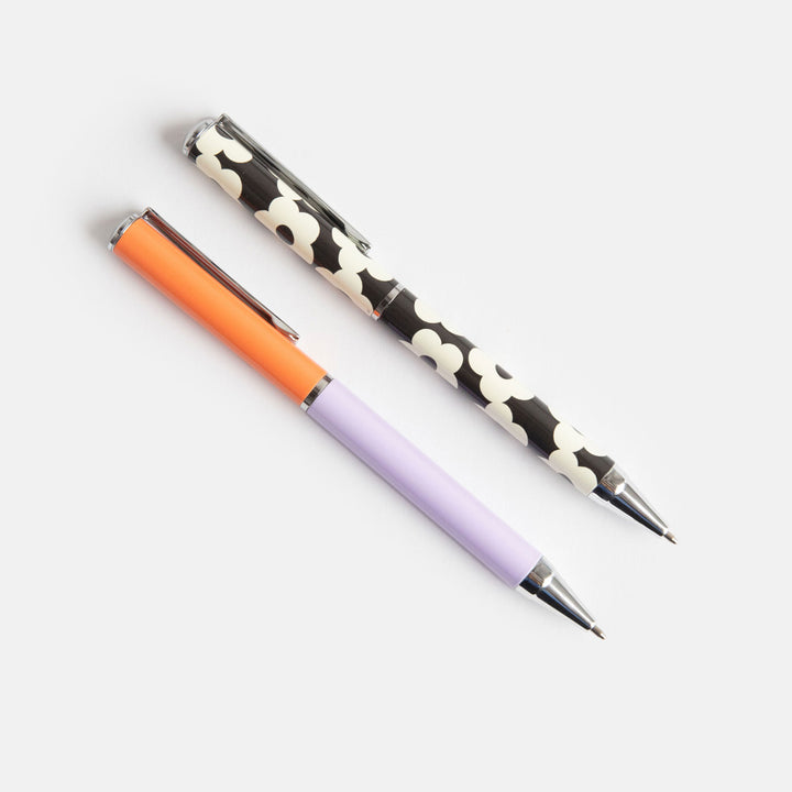set of 2 boxed ballpoint pens, one in block lilac & coral, the other in monochrome flowers print
