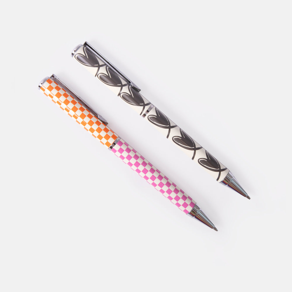 set of 2 ballpoint pens, one in colourful checkerboard design, the other in a monochrome looped hearts design