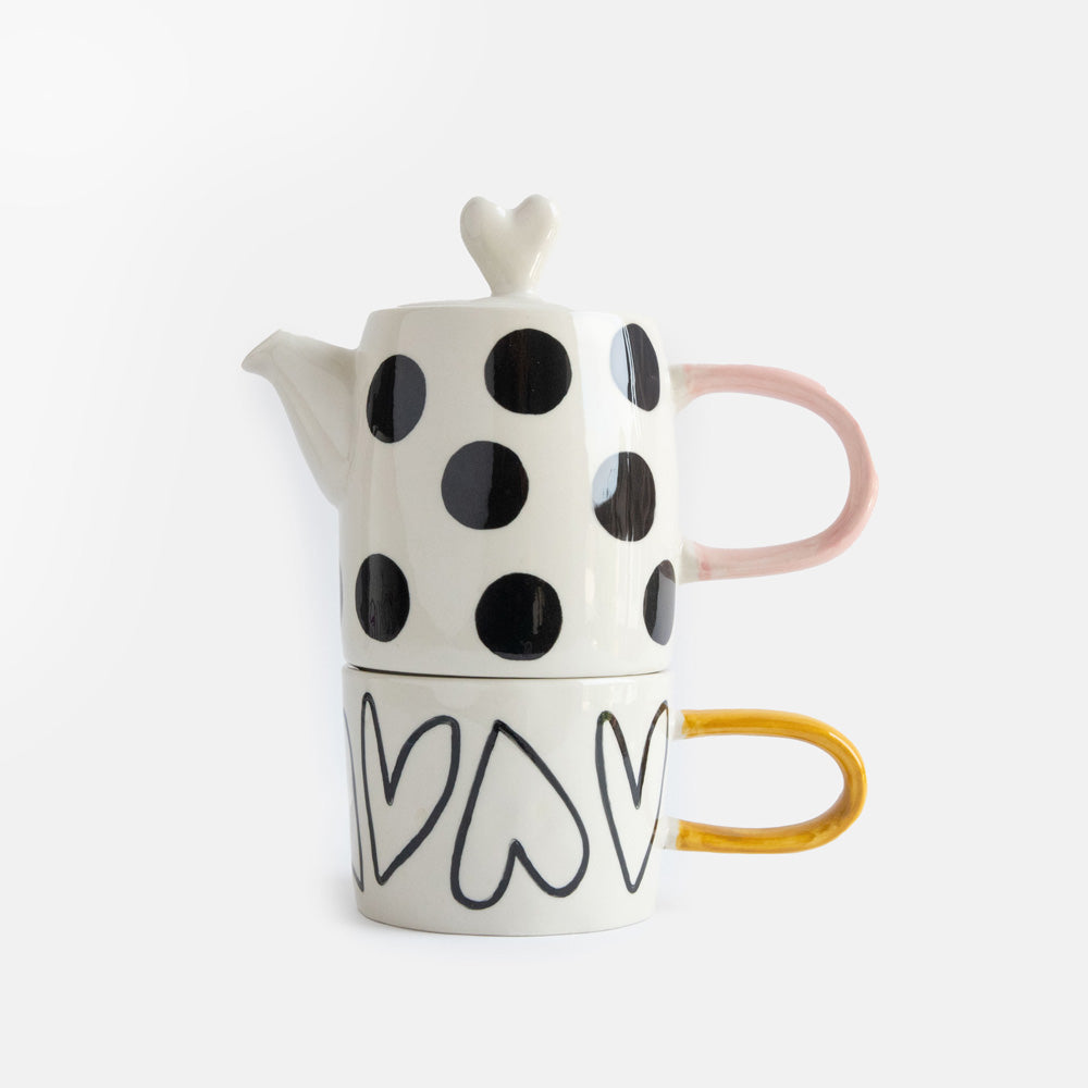hand painted ceramic set of teapot with black dots design, pink handle and heart shaped lid and cup with heart outlines and mustard handle 