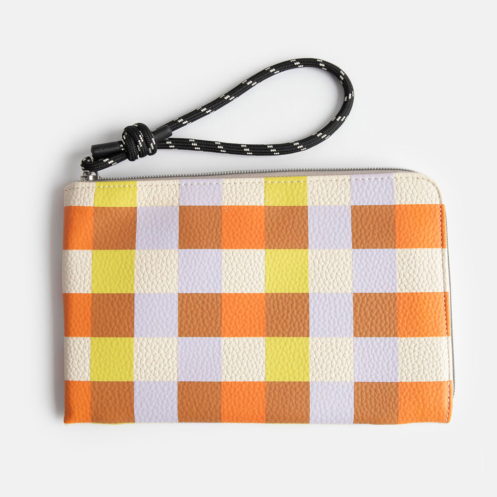 leather look PU travel pouch with internal pockets, with warm tones check design and a monochrome cord wrist strap