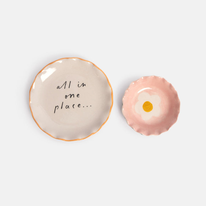 set of 2 trinket dishes with a small bowl with pink interior and flower design, and a larger dish with 'all in one place' wording