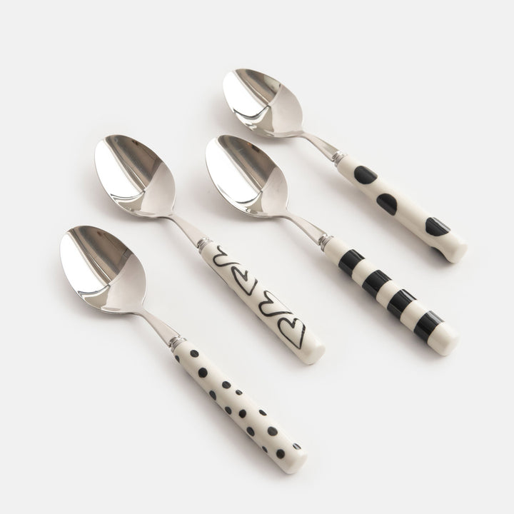 set of 4 hand painted stoneware & stainless steel teaspoons in white with black spots, stripes, dots and hearts designs. 