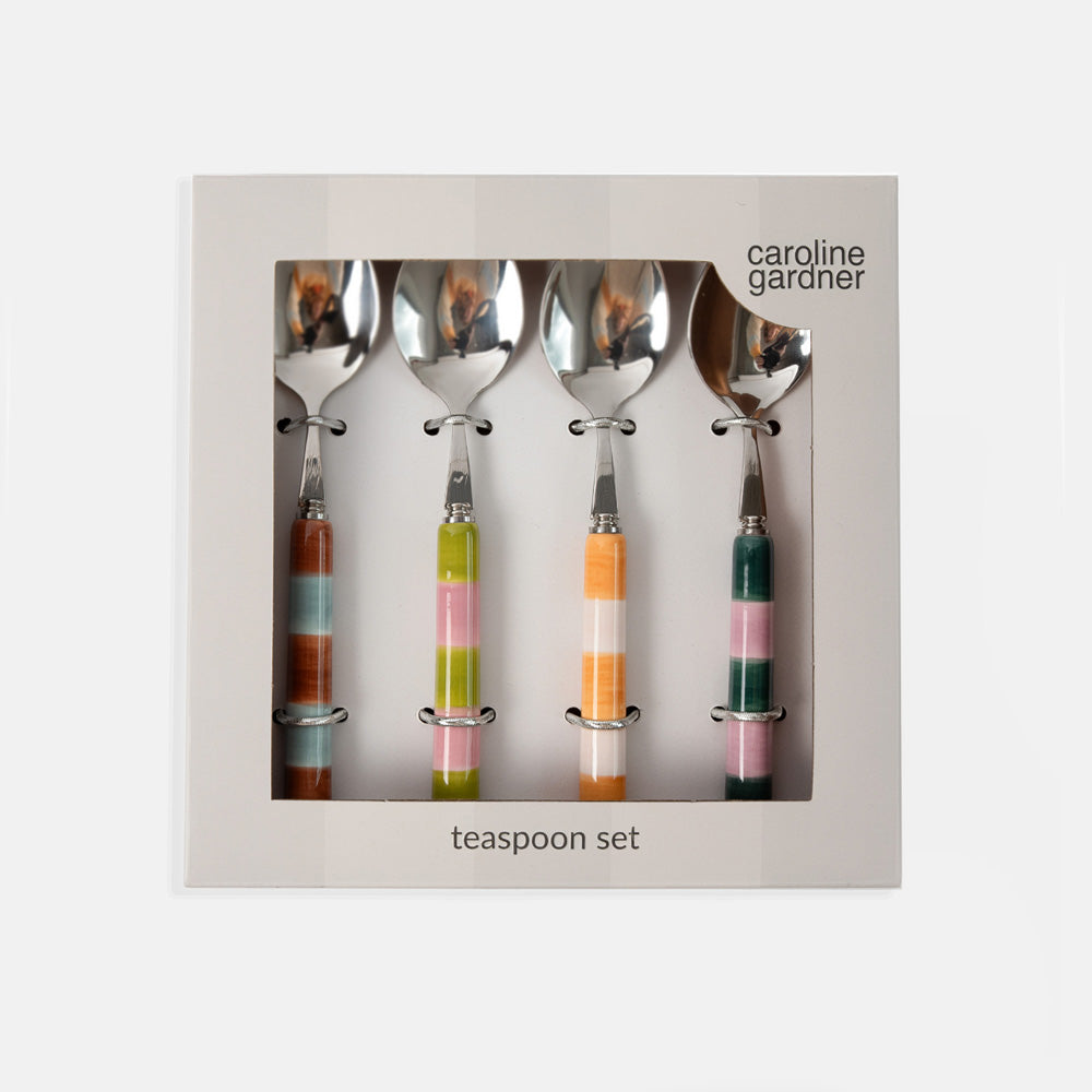 Caroline Gardner four-piece teaspoon set in a square gift box, featuring silver metal spoons with colorful striped handles in orange, green, pink, and brown.