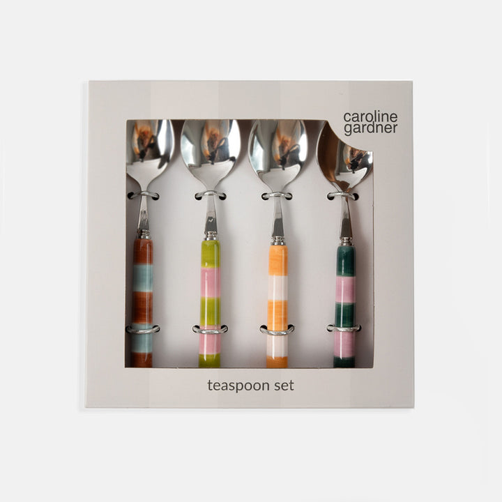 Caroline Gardner four-piece teaspoon set in a square gift box, featuring silver metal spoons with colorful striped handles in orange, green, pink, and brown.