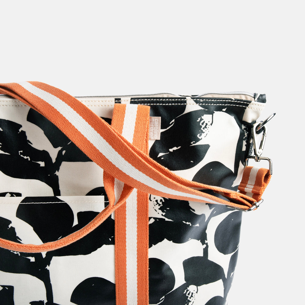 monochrome foliage print coated cotton canvas weekend bag with contrast orange webbing straps