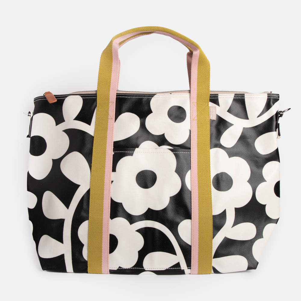 monochrome flower print coated canvas weekend bag with contrast webbing handles and strap