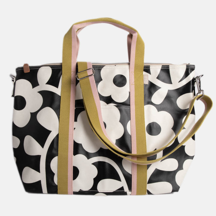 monochrome flower print coated canvas weekend bag with contrast webbing handles and strap