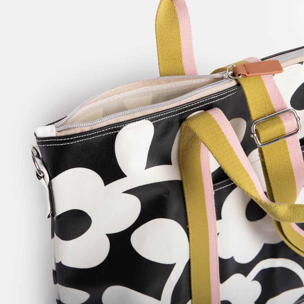 monochrome flower print coated canvas weekend bag with contrast webbing handles and strap