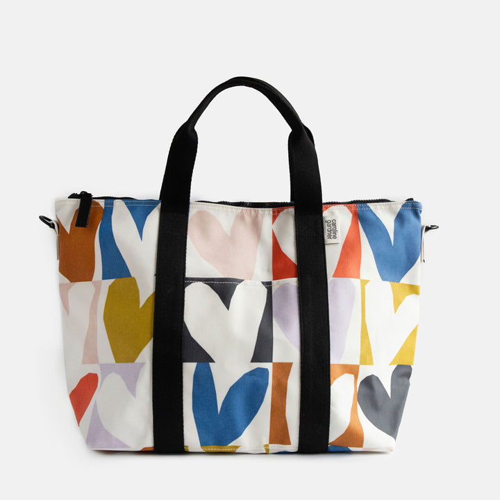 coated cotton canvas weekend bag with multicolour hearts design, black webbing grab handles and detachable shoulder strap 