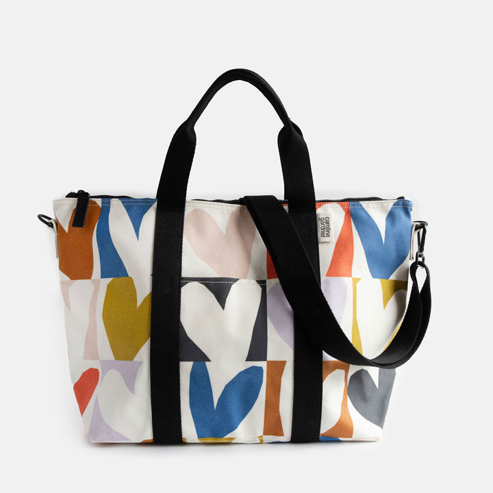 coated cotton canvas weekend bag with multicolour hearts design, black webbing grab handles and detachable shoulder strap 