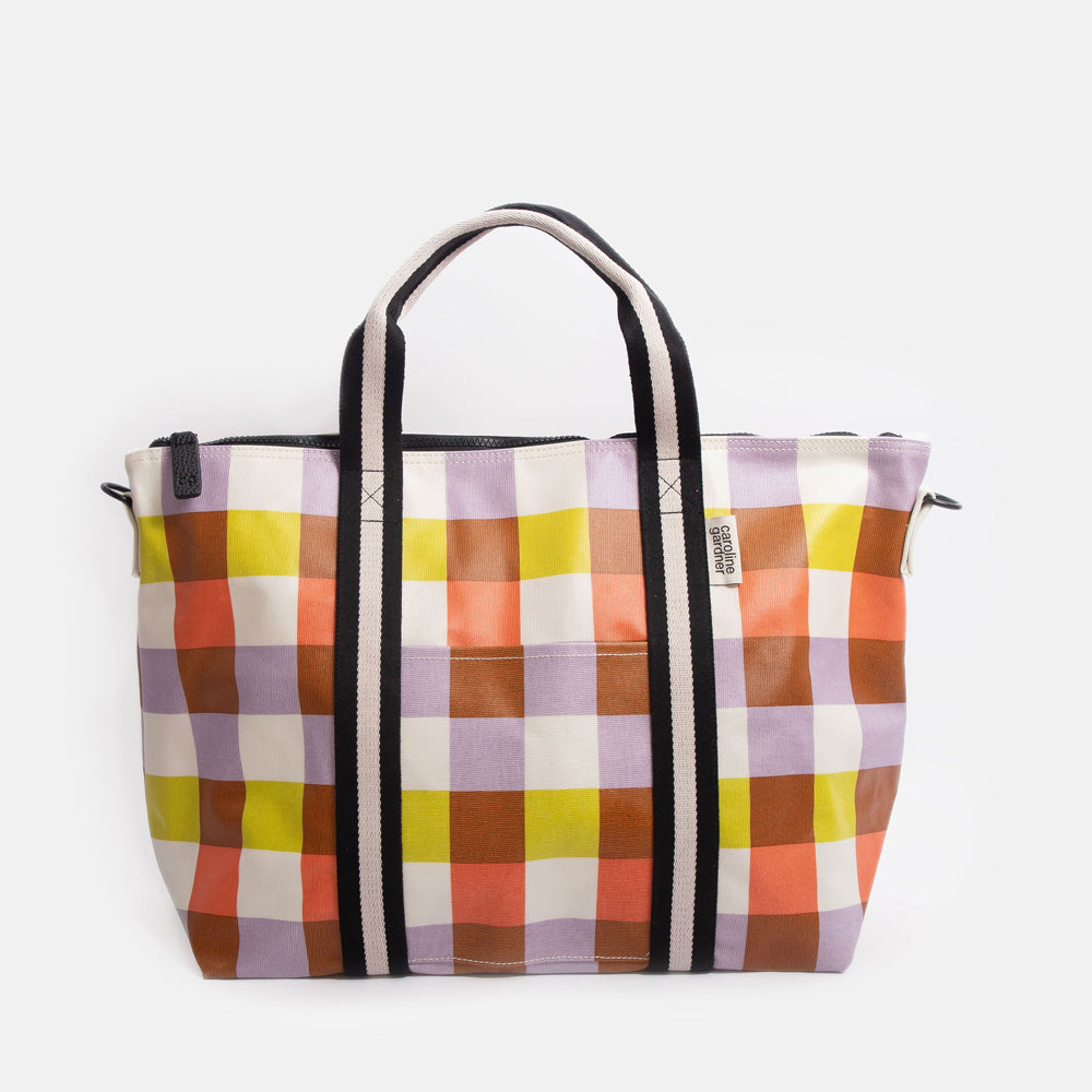 Colourful checked tote bag with black handles on a white background