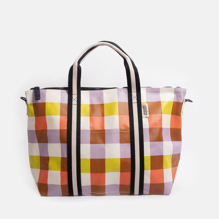 Colourful checked tote bag with black handles on a white background