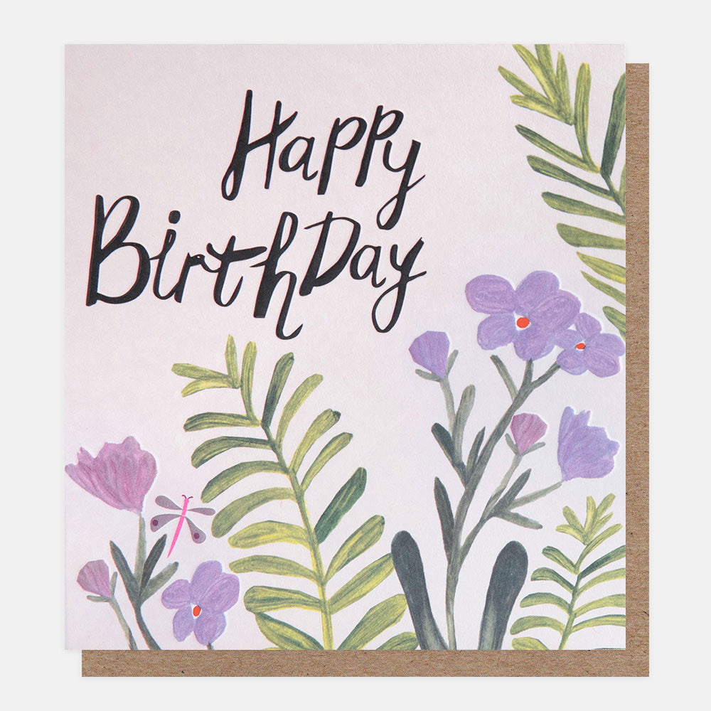 birthday card featuring a dragonfly amidst lilac flowers and 'happy birthday' message in black handwritten style lettering
