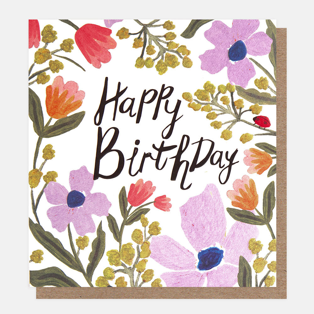 birthday card featuring a ladybird amidst colourful flowers and 'happy birthday' message in black handwritten style lettering

