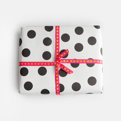 wrapping paper featuring black spots on a white background