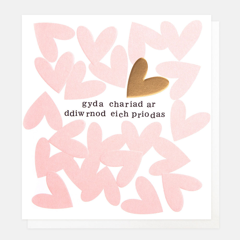 welsh language wedding card featuring pink hearts and the text gyda chariad ar ddiwrnod eich priodas