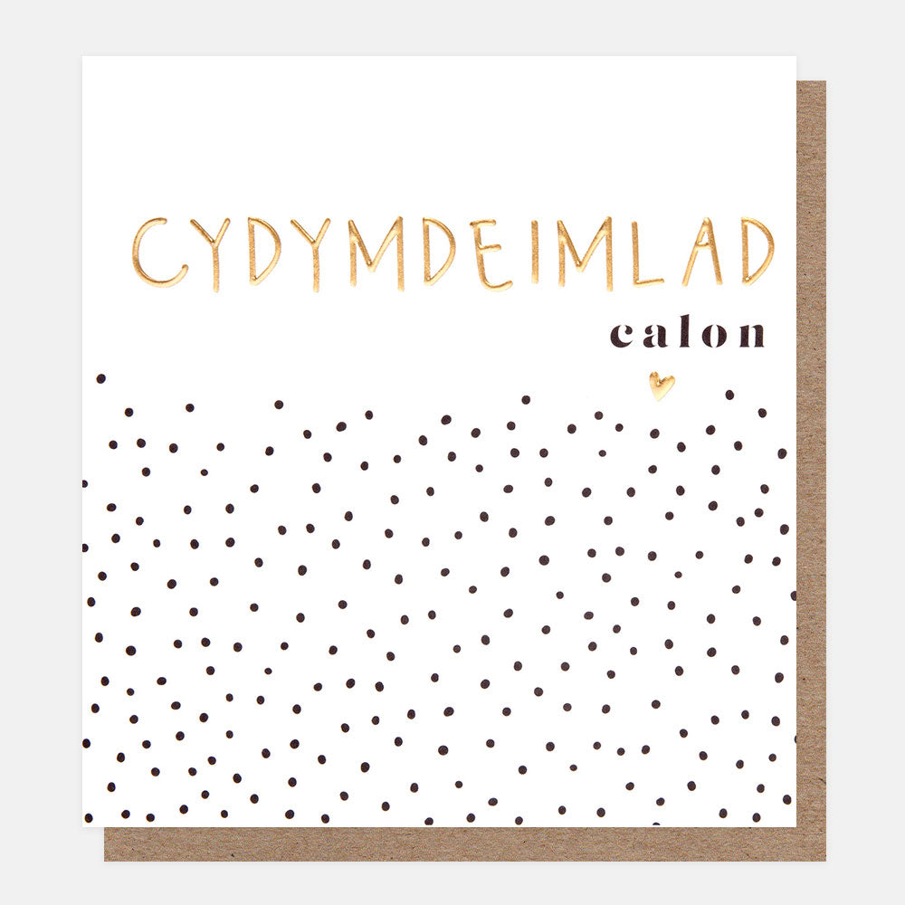 welsh language sympathy card featuring small black dots and a gold heart on a white background and the text cydymdeimlad calon