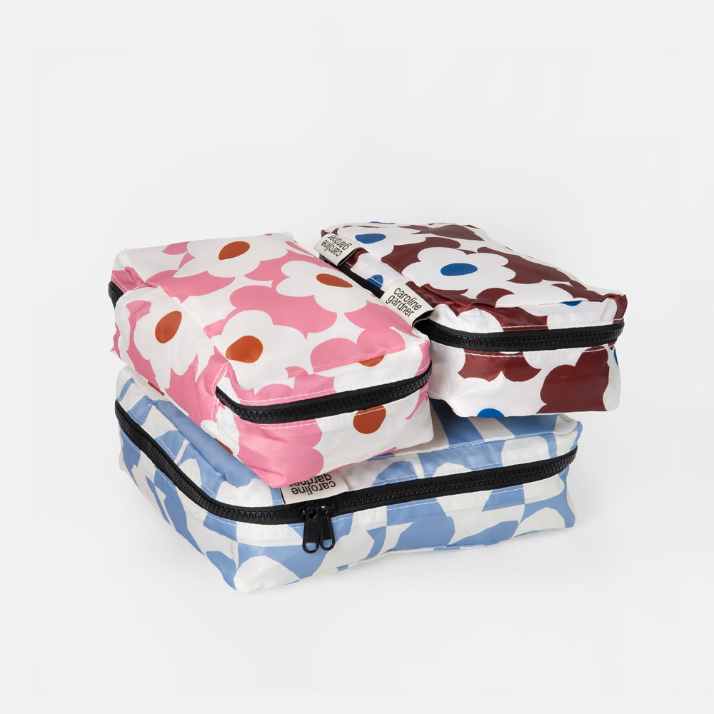 Three reusable zippered travel pouches stacked on top of each other, featuring the iconic Marime pattern in pink, brown, and blue on a white background.