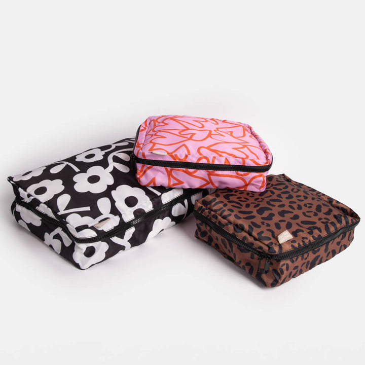 set of 3 packing cubes in different designs, one large, 2 medium