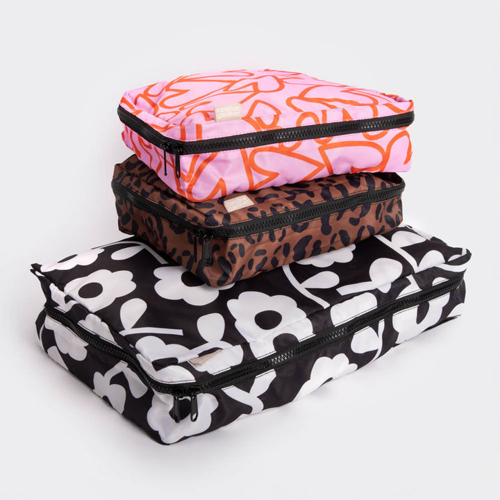 set of 3 packing cubes in different designs, one large, 2 medium