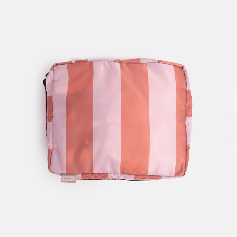 small packing cube in pink and orange candy stripe