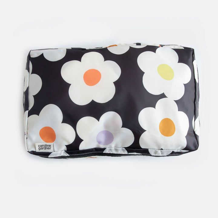 large packing cube in cream flowers with colourful centres on a charcoal background design