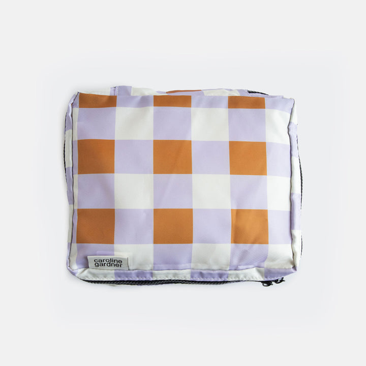small packing cube in a lilac and brown check design